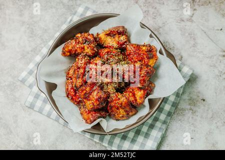 yangnyeom chicken, Korean style Seasoned Fried Chicken : This dish is seasoned chicken cut into pieces, deep- fried, and mixed with soy sauce, gochuja Stock Photo