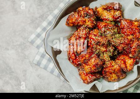 yangnyeom chicken, Korean style Seasoned Fried Chicken : This dish is seasoned chicken cut into pieces, deep- fried, and mixed with soy sauce, gochuja Stock Photo