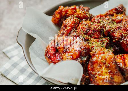 yangnyeom chicken, Korean style Seasoned Fried Chicken : This dish is seasoned chicken cut into pieces, deep- fried, and mixed with soy sauce, gochuja Stock Photo