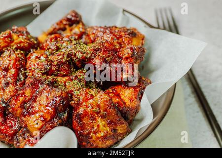 yangnyeom chicken, Korean style Seasoned Fried Chicken : This dish is seasoned chicken cut into pieces, deep- fried, and mixed with soy sauce, gochuja Stock Photo