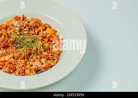 Korean food Kimchi Fried Rice Kimchibokkeumbap, Rice fried with finely chopped kimchi. Beef, pork, onions, green onions, and other vegetables may be a Stock Photo