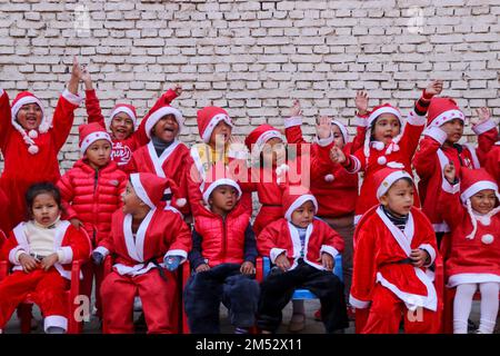 Kathmandu, NE, Nepal. 25th Dec, 2022. Children in a Santa Claus costume