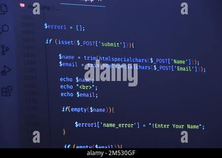 The software developer is doing php coding. Abstract code background. Selective focus code on computer screen Stock Photo