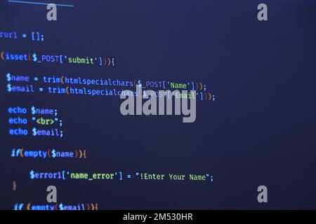 Programmer coding python, java script, html code on notebook screen at home. Work from home. Stock Photo