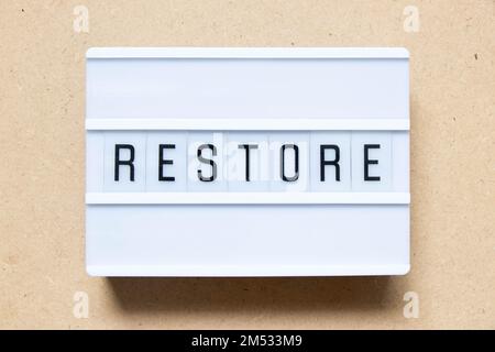 Lightbox with word restore on wood background Stock Photo
