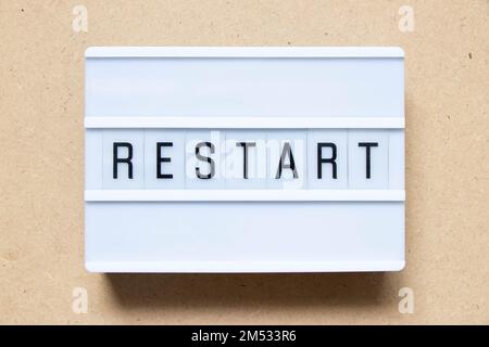 Lightbox with word restart on wood background Stock Photo