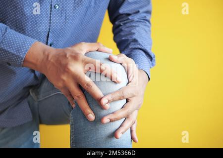 Close up on man suffering knee joint pain Stock Photo