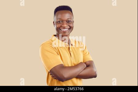 Happy African American man standing with his arms crossed, looking at camera and smiling Stock Photo
