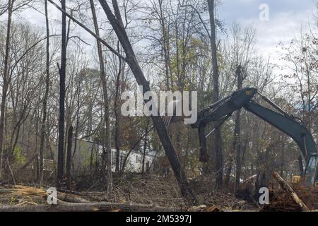 Tractor or skid steer clearing land from roots for building housing ...