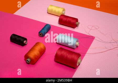 Coils of multicolored threads on a colored background Stock Photo