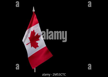 Small national flags of the Canada on a black background Stock Photo