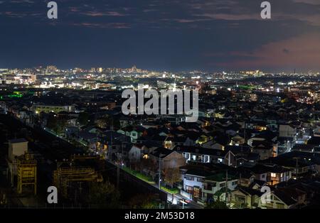 Houses in dark residential neighborhood near city at night Stock Photo