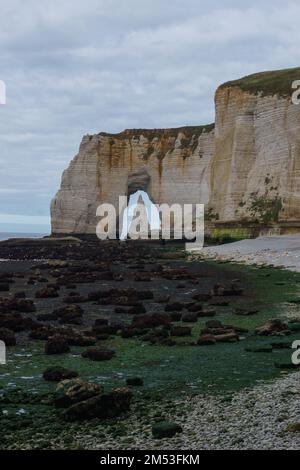 The Manneporte cliff with the Needle seen through the arch in Etretat ...
