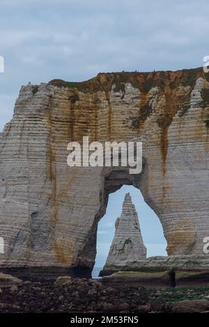 The Manneporte cliff with the Needle seen through the arch in Etretat ...