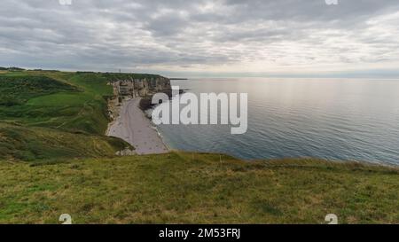 View at the Alabaster coast with beach Plage du Tilleul on a cloudy summer day, Etretat, Normandy, France Stock Photo