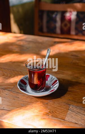 Cup of turkish tea on a wooden table in a cafe. Stock Photo