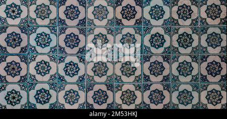 The texture of the ceramic tiles in the oriental style. Turkish ceramic tiles lined up on the wall. Stock Photo