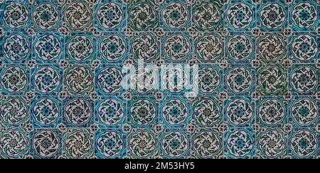 The texture of the ceramic tiles in the oriental style. Turkish ceramic tiles lined up on the wall. Stock Photo