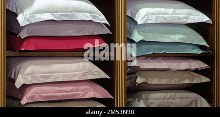 Multicolored pillows on a shelf in a dressing room, hotel service concept Stock Photo