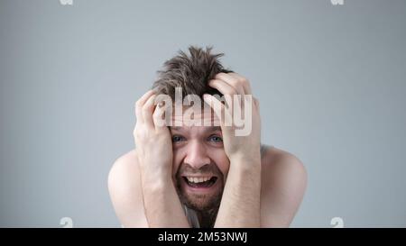 Scared caucasian guy shivering from fear, looking afraid and insecure at camera. Stock Photo