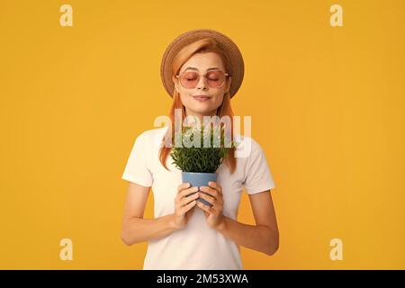 Woman planting flowers in pot. Girl hold flower pot. Concept of growing plants. Summer female gardener. Stock Photo