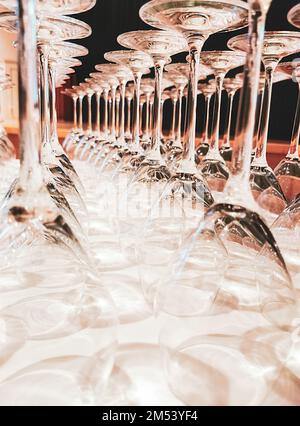 Polished wine glasses hanging over a bar rack, restaurant concept, stock photo Stock Photo