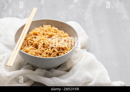 Fresh tasty noodles with vegetables in white big bowl Stock Photo