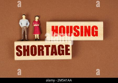 Business and people concept. On wooden blocks with the inscription - Home ownership, there are miniature figures of people. Stock Photo