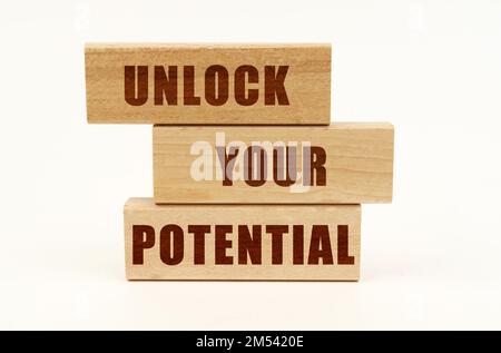 Business concept. On a white surface are wooden blocks with the inscription - Unlock Your Potential Stock Photo