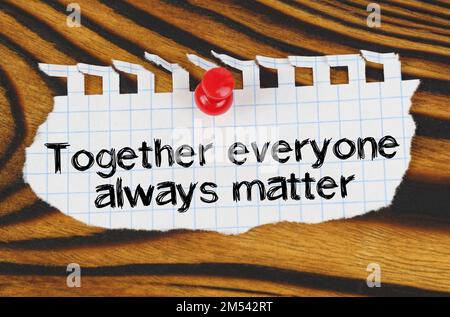 Business concept. Attached to the board is an announcement with the inscription - together everyone always matter Stock Photo