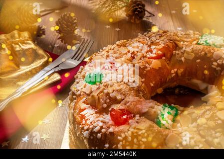Close-up of an Epiphany cake "Roscon de Reyes" on a wooden table. Typical Spanish dessert eaten on the day of the Three Wise Men at Christmas Stock Photo