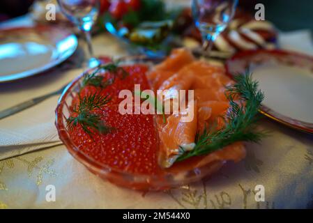 Russian New Year's table. Red fish, caviar and glasses for vodka. Stock Photo