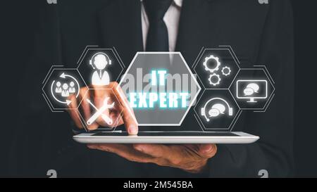 IT expert concept, Person hand using digitla tablet with IT expert icon on virtual screen, Information Technology Advice or Services. Stock Photo