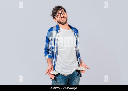 Sad man with no money showing his empty pockets, Unemployed people showing their empty pockets. Frustrated unemployed young man showing his empty Stock Photo
