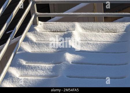 White snow-covered surface. Wood planks covered with fluffy melting snow. Stock Photo