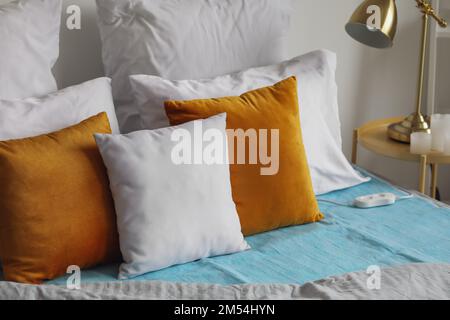 Bed with electric heating pad in bedroom Stock Photo