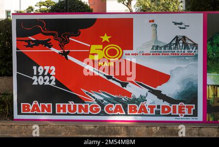 A Communist party propaganda poster in front of the Hanoi People's Committee building in the centre of the Vietnamese capital city.  The poster commem Stock Photo