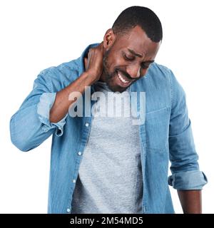 Ouch. Studio shot of a young man holding his neck in pain against a white background. Stock Photo