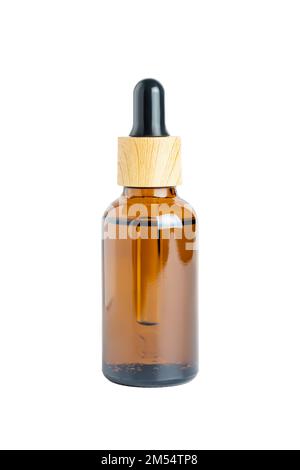 Amber glass bottle dropper with bamboo lid isolated on white background by clipping path. Skin care madicine and cosmetology mockup. Stock Photo