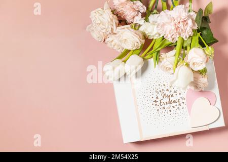 Happy Valentine's Day greeting card, gift box and beautiful spring flowers on light pink background. Valentine's day, Womans day, mothers day greeting Stock Photo