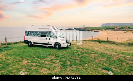 Camper van parked next to beach at summer Stock Photo