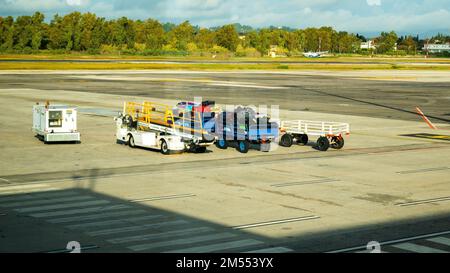Kerkyra, Greece - 09 29 2022: View in Corfu Airport On Empty And Loaded Carts With Luggage in Sunny Weather. Stock Photo