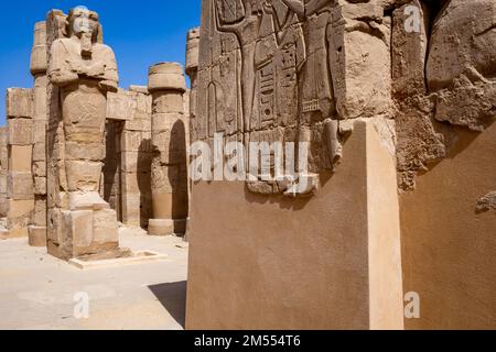 Hieroglypic painted carvings on wall at the ancient egyptian temple in Luxor. Egypt. Stock Photo