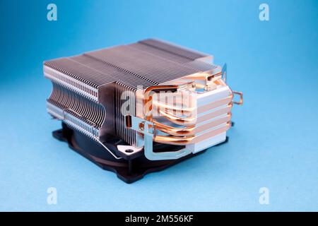 Computer heatsink cooler on blue background. Detail of a personal computer. Stock Photo