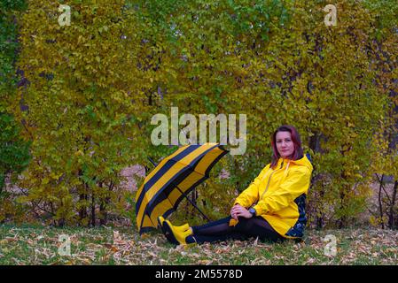 yellow black umbrella and girl in yellow Stock Photo