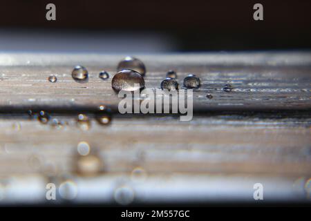Close up of water drops on impregnated wooden surface. Stock Photo