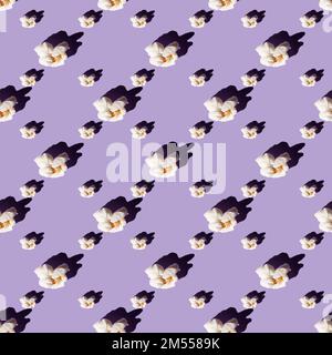 Delicious popcorn on a purple background. Seamless pattern. Culture of cinema ,domestic leisure with friends . Stock Photo