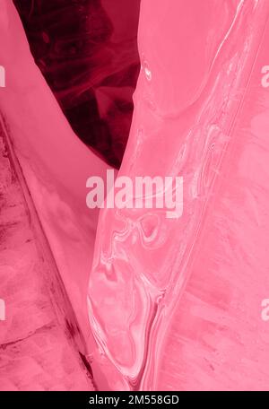 Ice hammocks of Baikal lake. Abstract winter nature background. Toned image in trendy magenta color of year 2023. Stock Photo