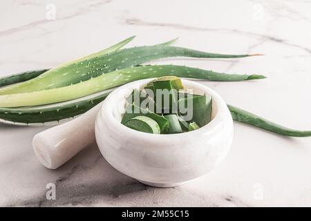 Aloe Vera Leaf Next To A Jar With Natural Aloe Cream On A Yellow 