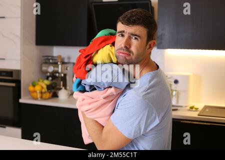 Cute man doing the laundry Stock Photo